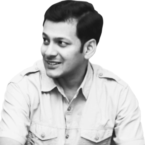 Raghavendra Shet, smiling, in a black-and-white portrait.