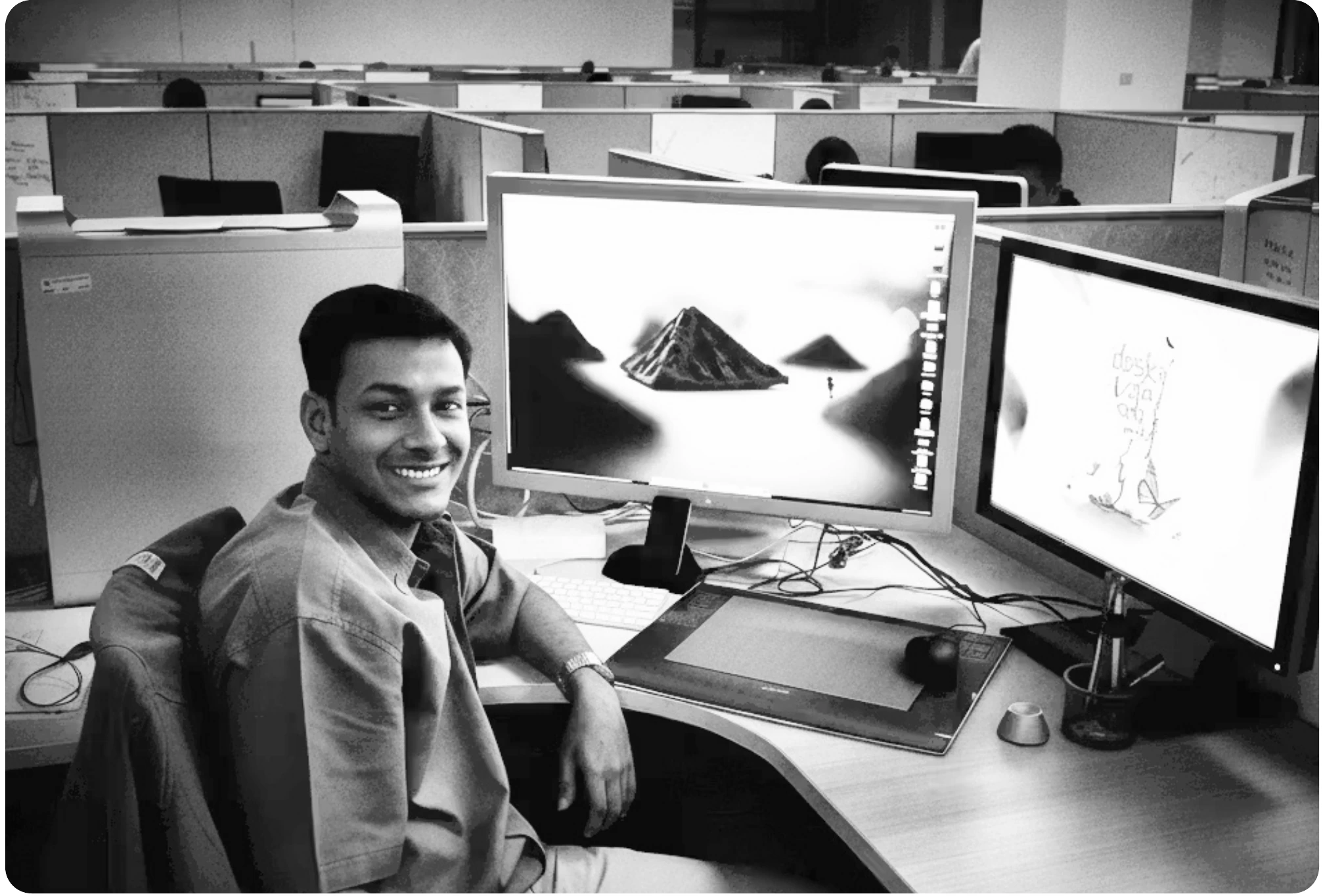Raghavendra at a studio desk in the early service years, working on a 3D scene across two monitors.